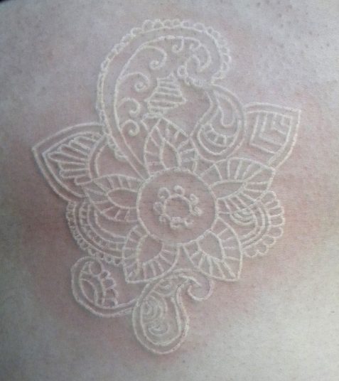 white ink tattoo on pale skin