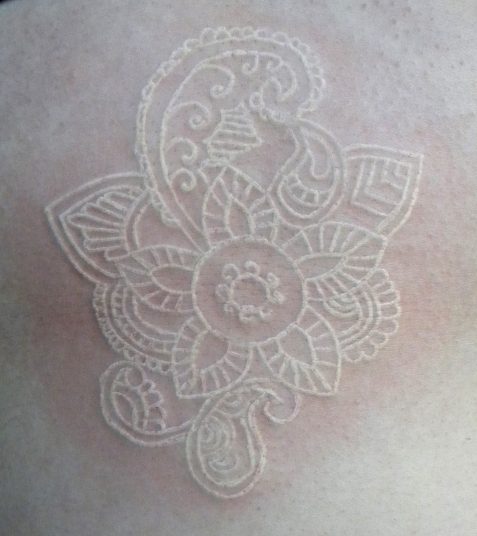 White ink tattoo on pale skin