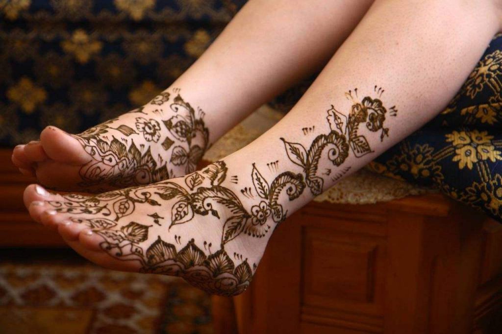 Black henna ink tattoo designs on foot