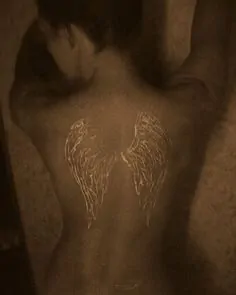 Amazing white tattoo of wings for woman
