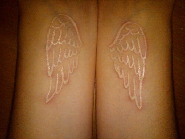 Pait of delicate white wings tattoo