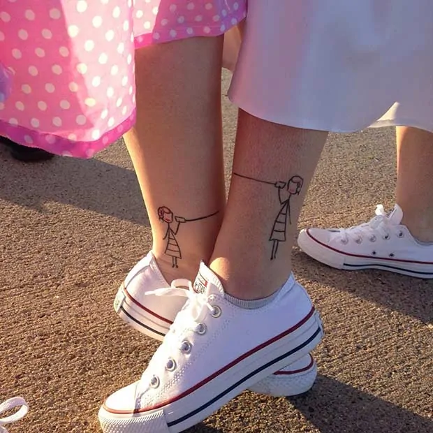 sisters matching foot tattoos