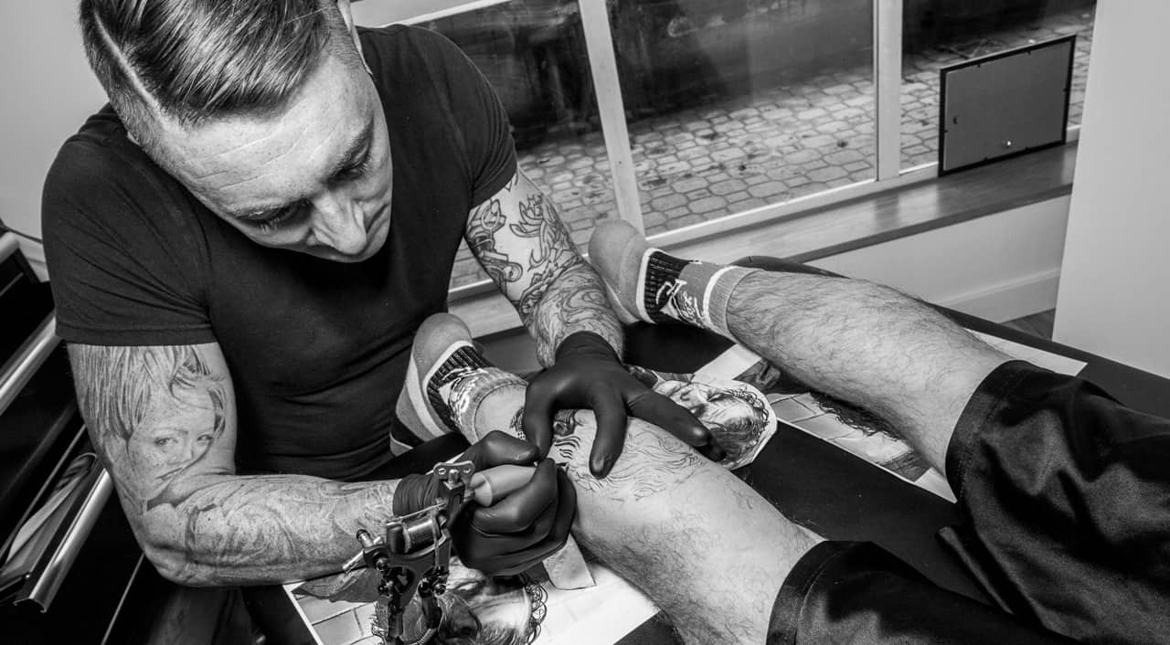 Tattoo artist tattooing