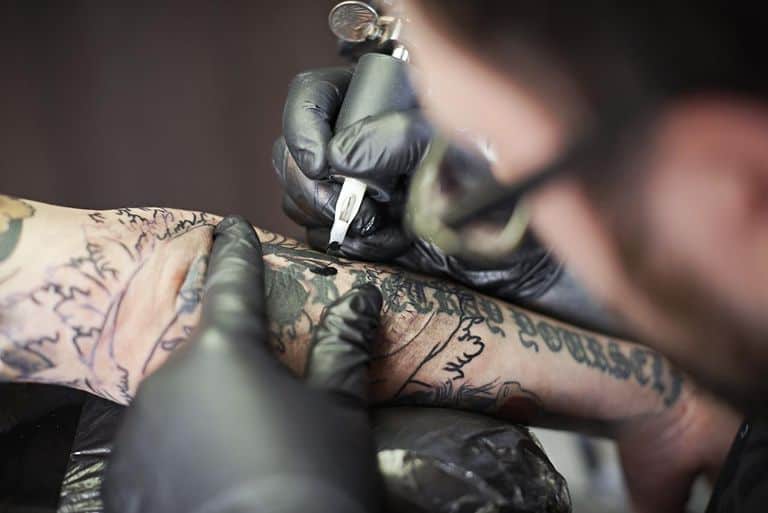 Man tattoo artist at work