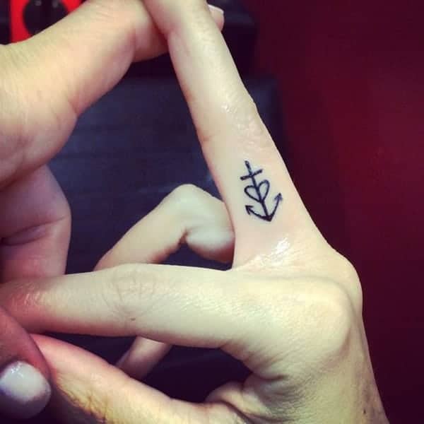 anchor with cross finger tattoo